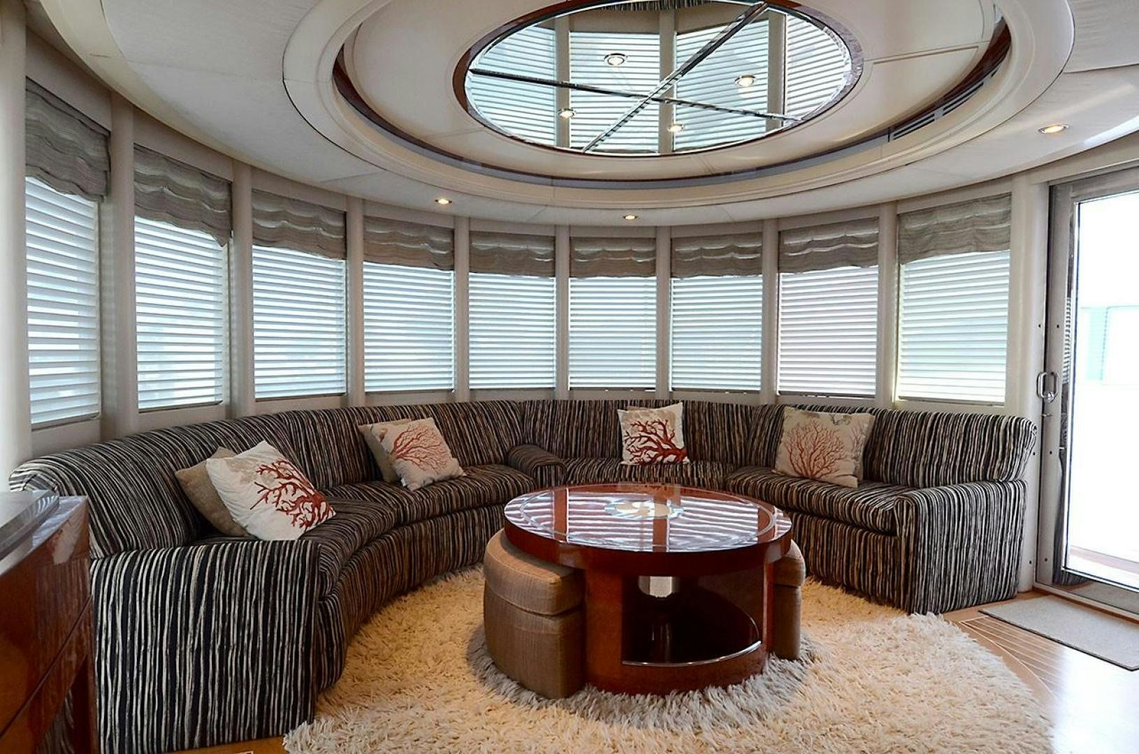a living room with a large chandelier aboard ARTHUR'S WAY Yacht for Sale