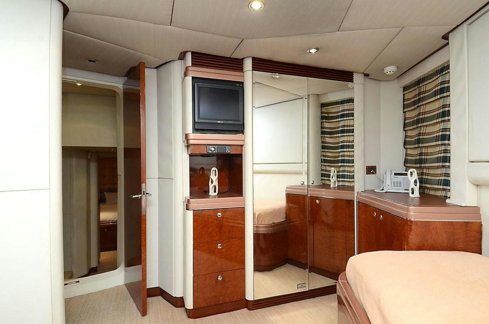 a room with a bed and a television aboard ARTHUR'S WAY Yacht for Sale