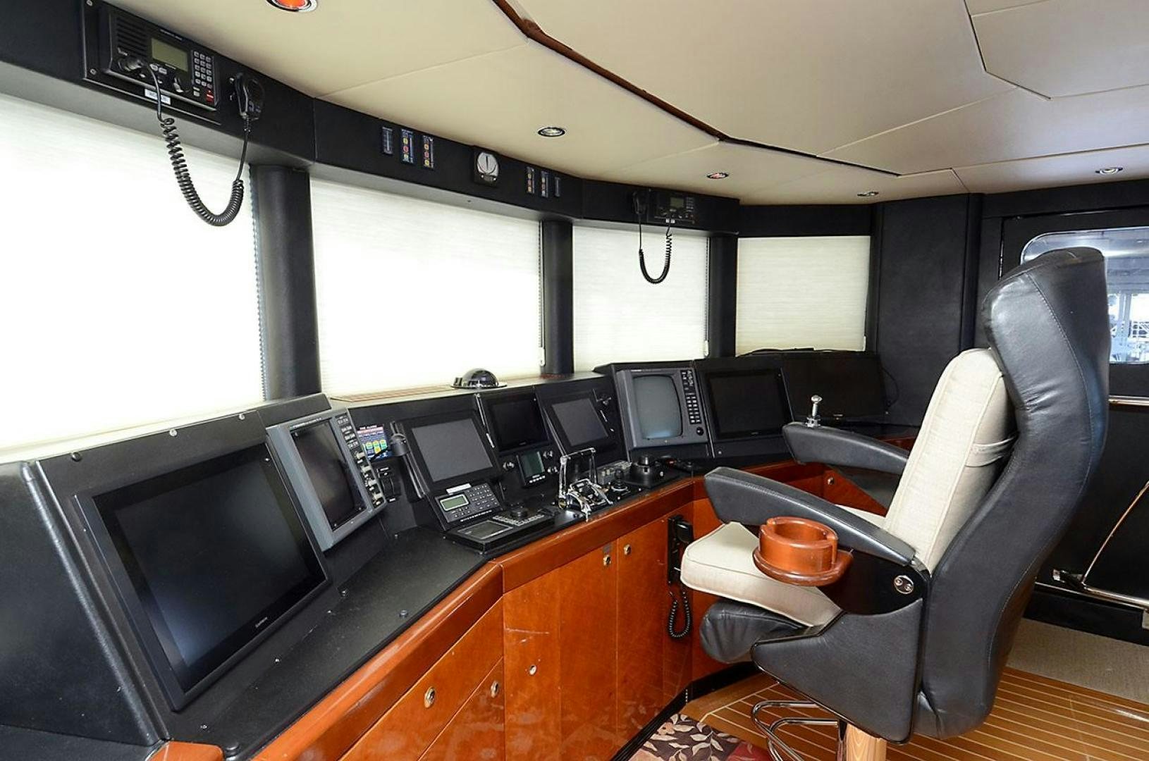 a kitchen with a black counter and black chairs aboard ARTHUR'S WAY Yacht for Sale