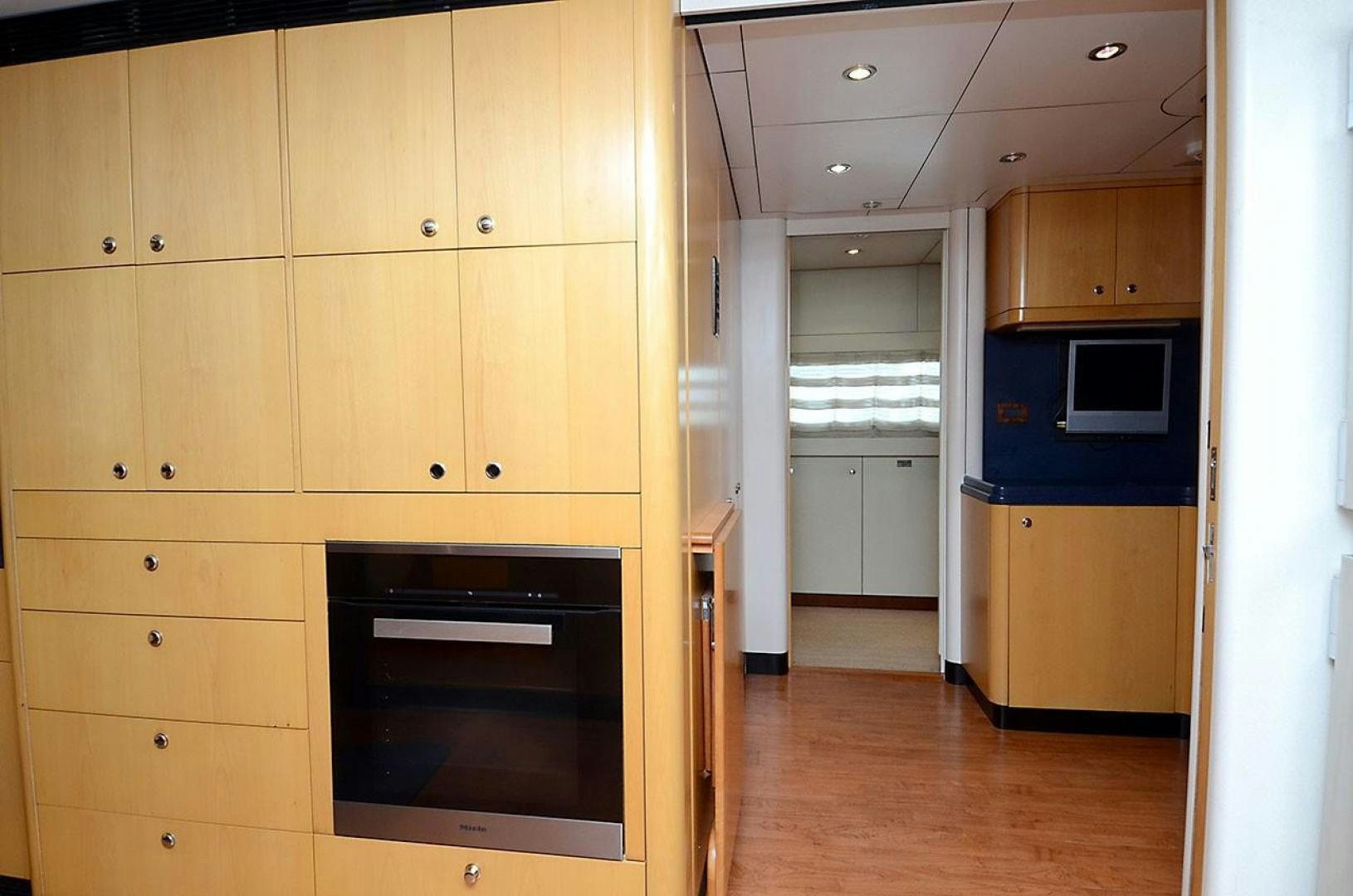 a kitchen with wooden cabinets aboard ARTHUR'S WAY Yacht for Sale