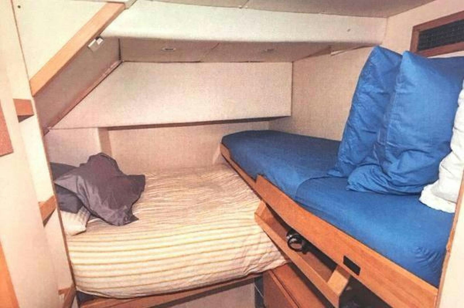 a bed with a wooden frame aboard ARTHUR'S WAY Yacht for Sale