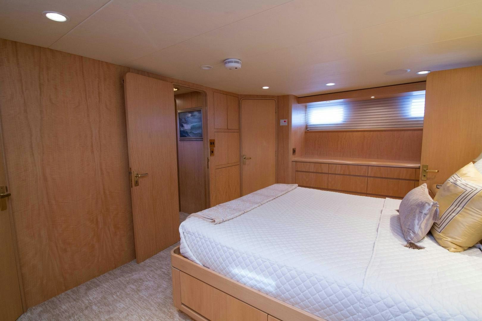 a bedroom with a bed and a closet aboard ROAMIN' HOLIDAY Yacht for Sale