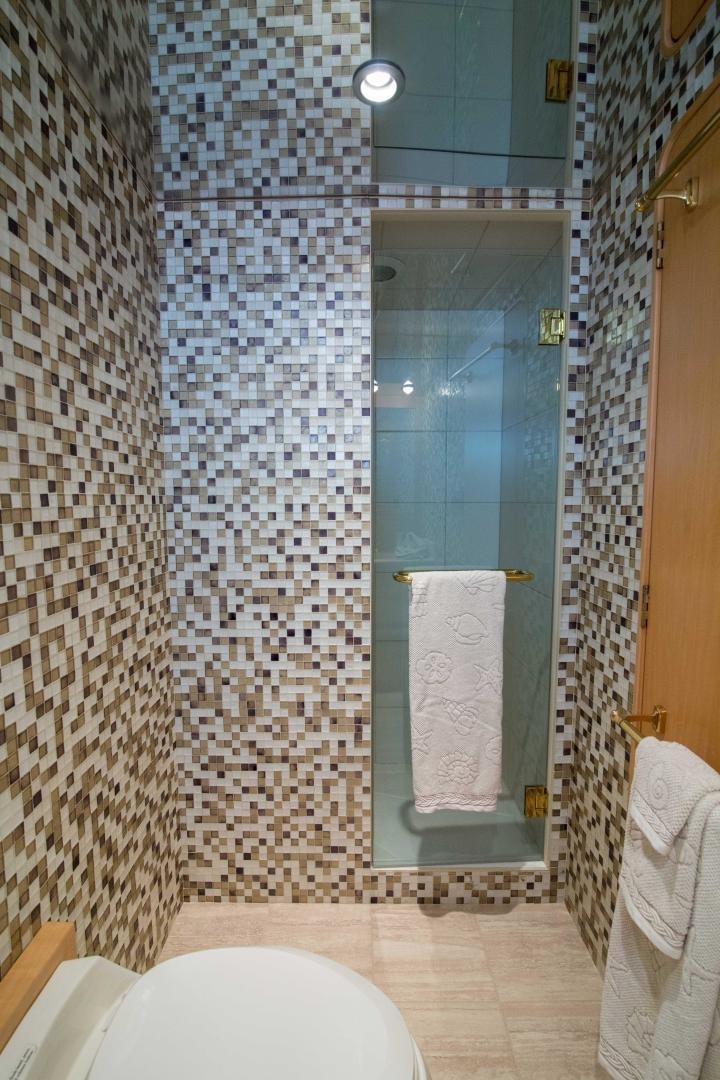 a bathroom with a glass shower aboard ROAMIN' HOLIDAY Yacht for Sale
