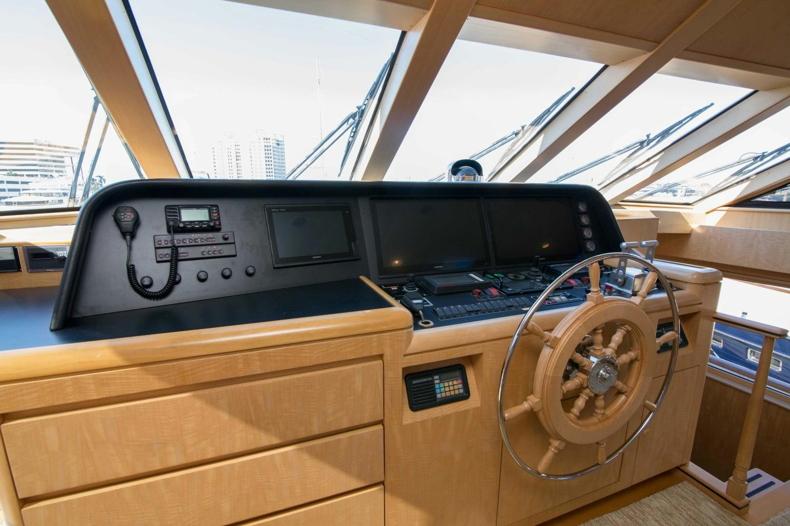 a large wooden desk with a computer and a steering wheel aboard ROAMIN' HOLIDAY Yacht for Sale