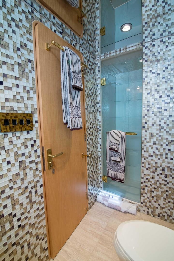 a bathroom with a shower unit and toilet aboard ROAMIN' HOLIDAY Yacht for Sale