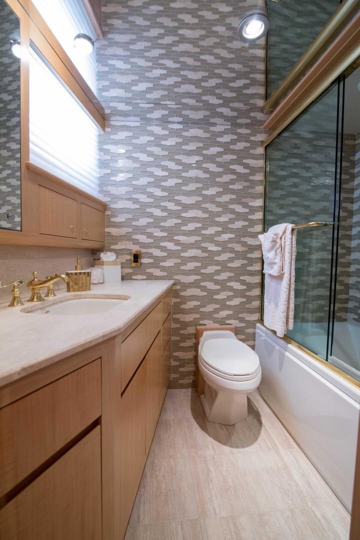 a bathroom with a toilet sink and a bathtub aboard ROAMIN' HOLIDAY Yacht for Sale