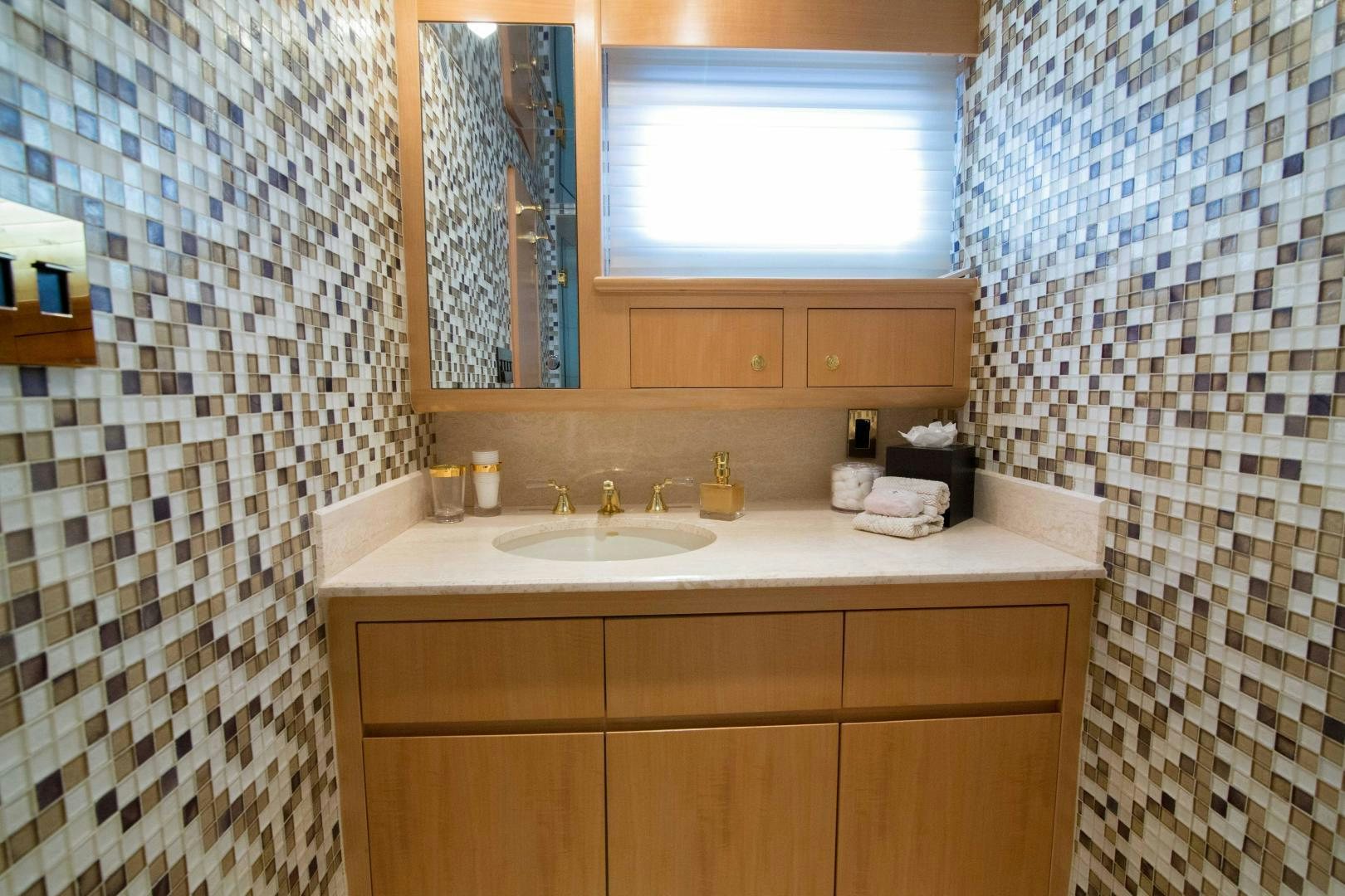 a bathroom with a sink and a shower curtain aboard ROAMIN' HOLIDAY Yacht for Sale