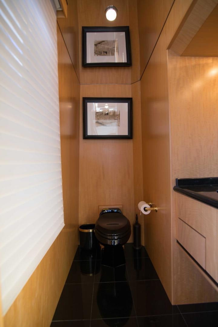 a bathroom with a toilet and a picture on the wall aboard ROAMIN' HOLIDAY Yacht for Sale