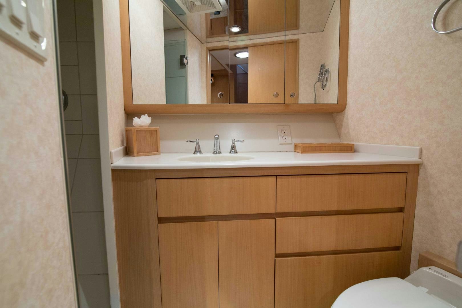 a bathroom with a sink and a mirror aboard ROAMIN' HOLIDAY Yacht for Sale