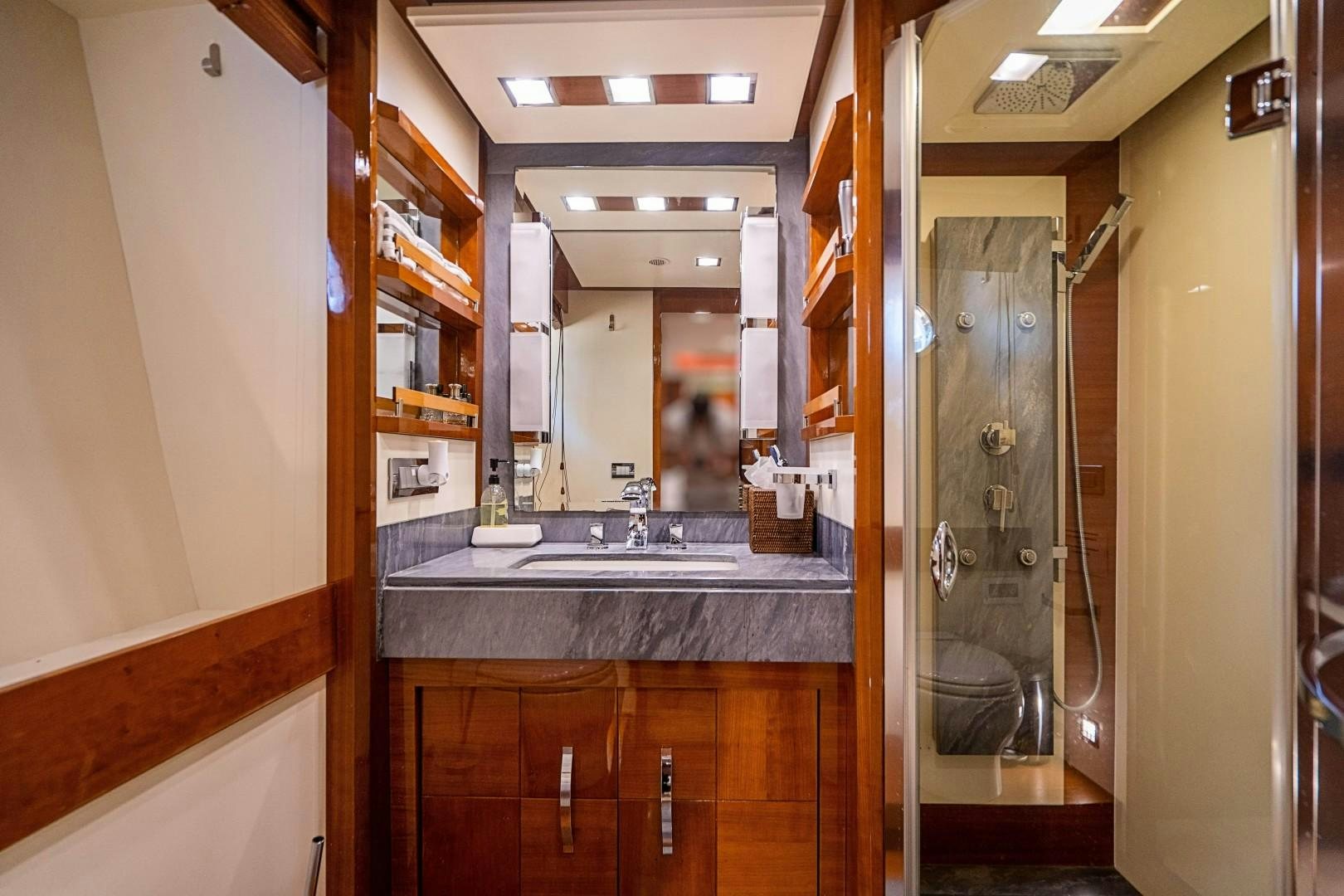 a bathroom with a sink and mirrors aboard Blue Yacht for Sale