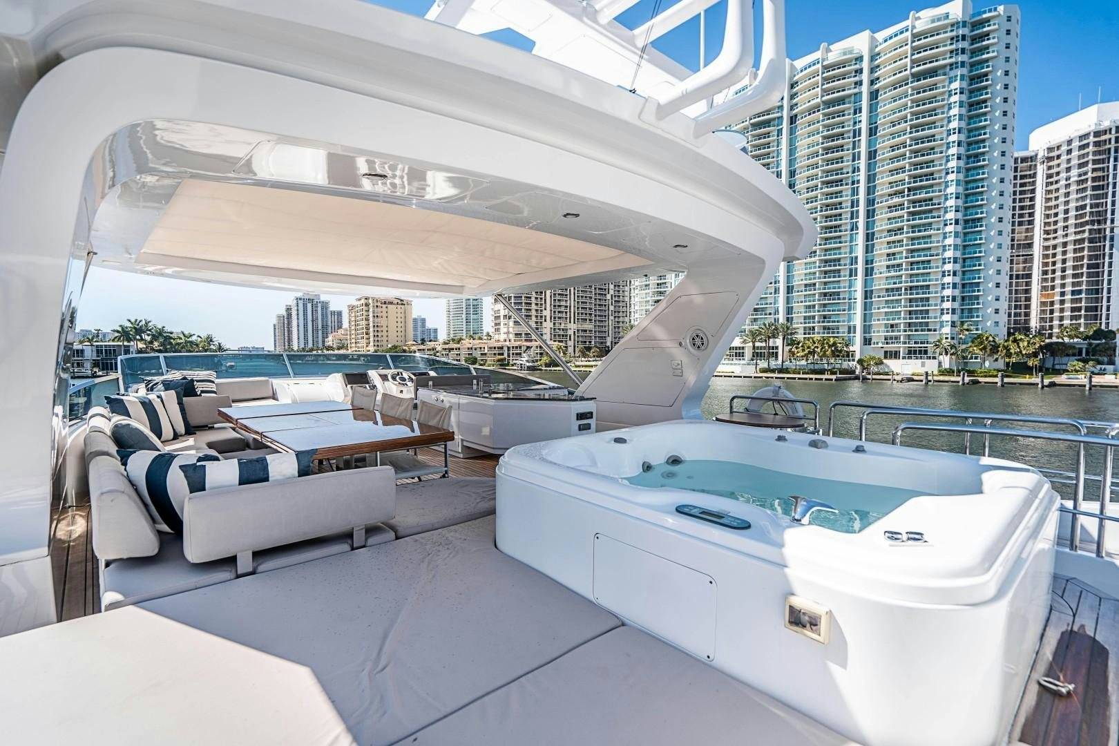 a large white yacht in a large room with a large building in the background aboard Blue Yacht for Sale