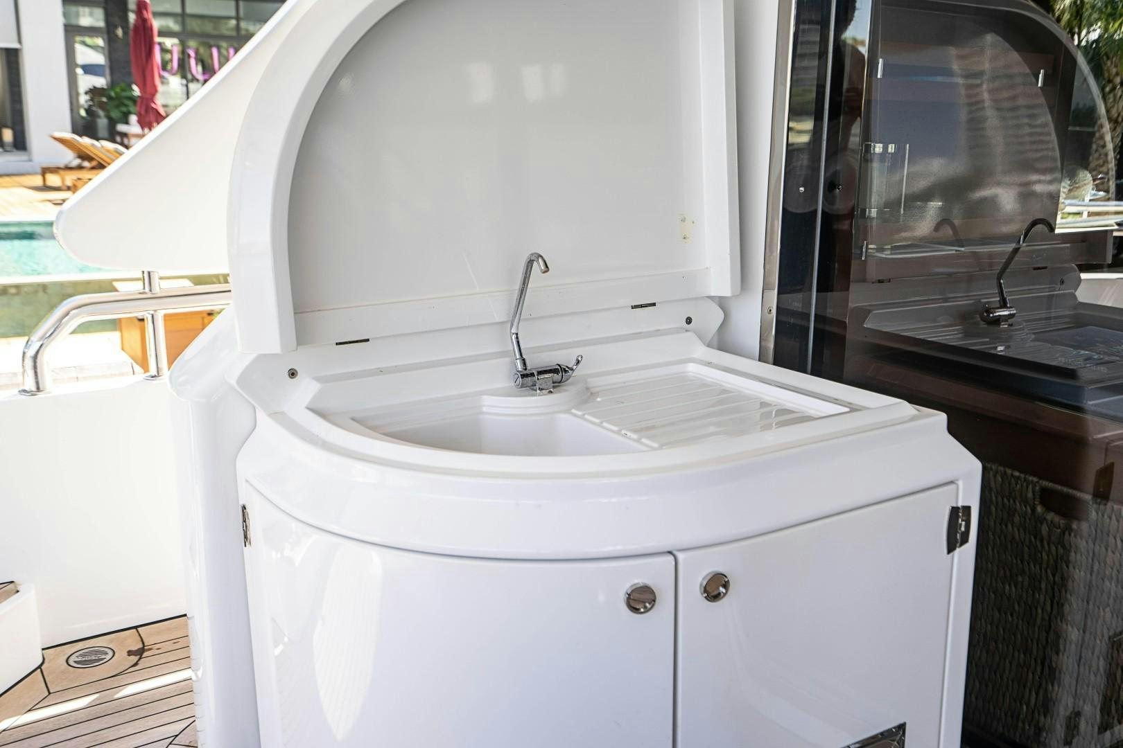 a white washing machine aboard Blue Yacht for Sale