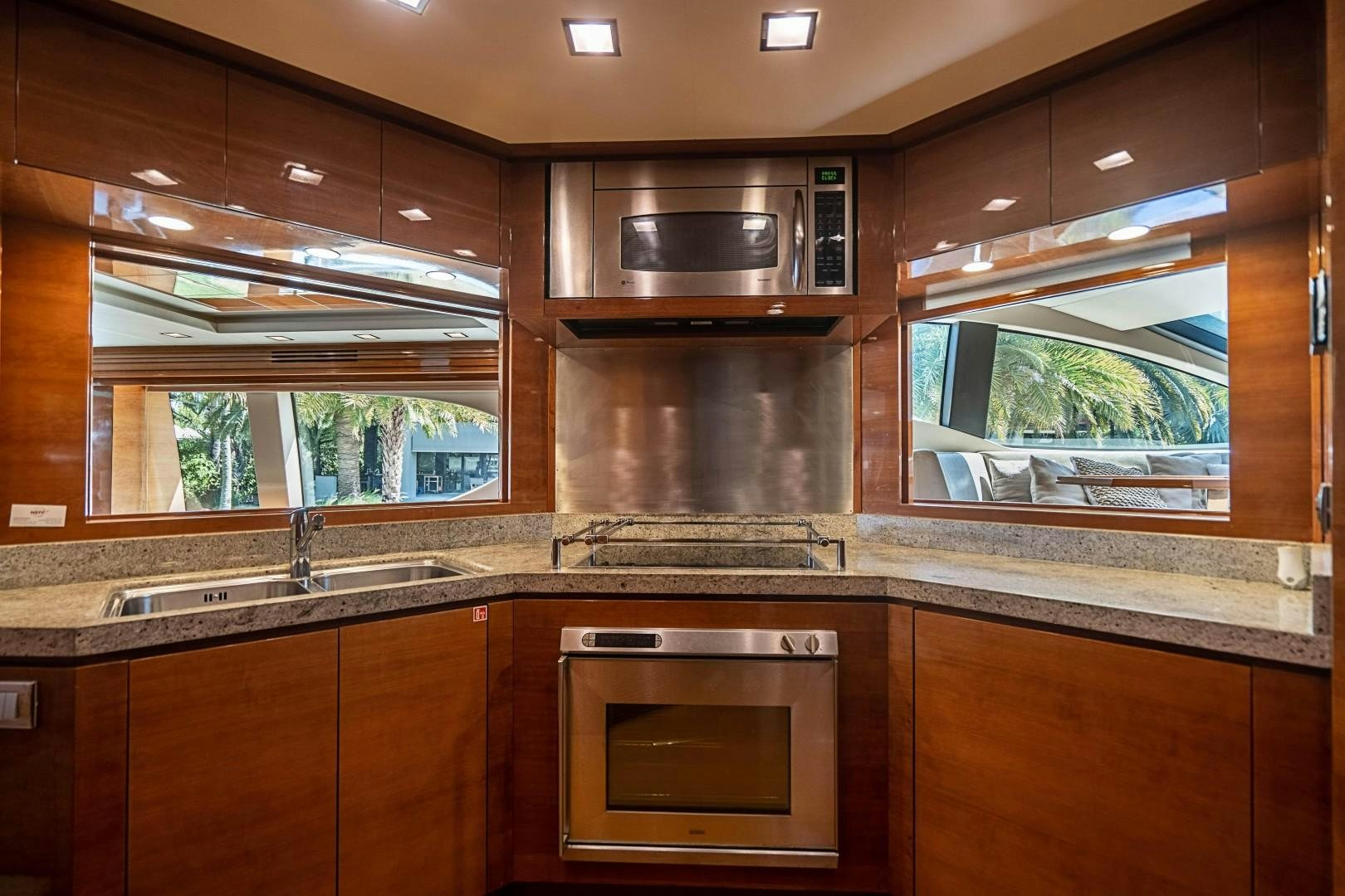 a kitchen with wooden cabinets aboard Blue Yacht for Sale