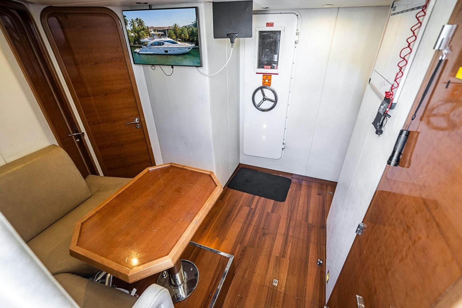 a living room with a table and couches aboard Blue Yacht for Sale