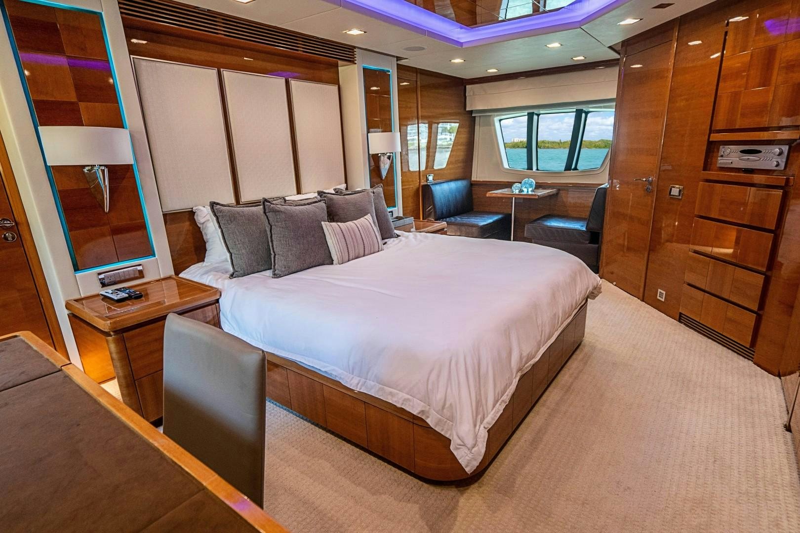 a hotel room with a bed and desk aboard Blue Yacht for Sale