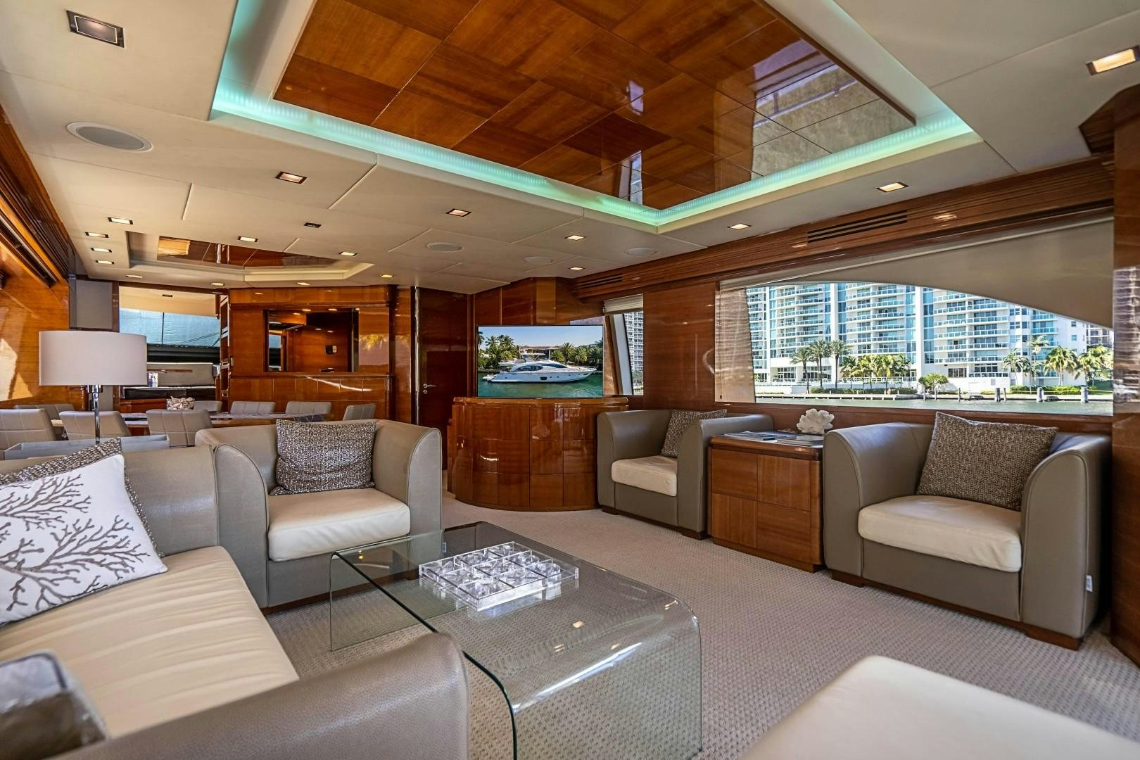a living room with a large window aboard Blue Yacht for Sale