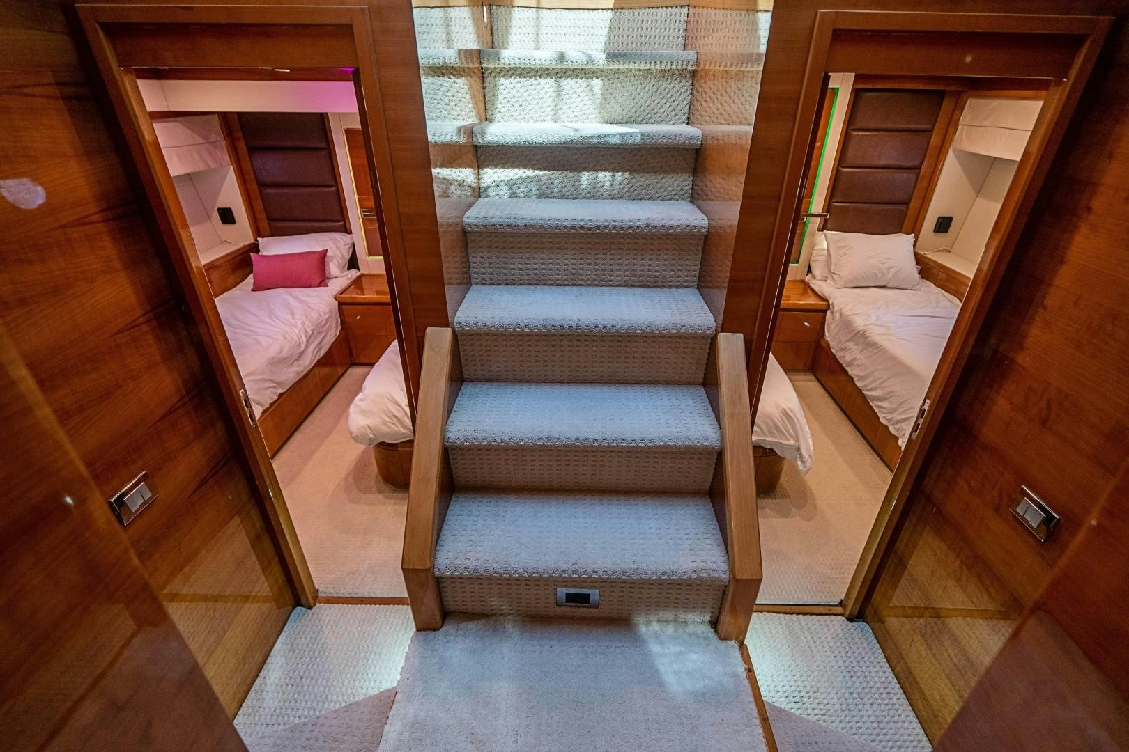 a room with a bed and a mirror aboard Blue Yacht for Sale