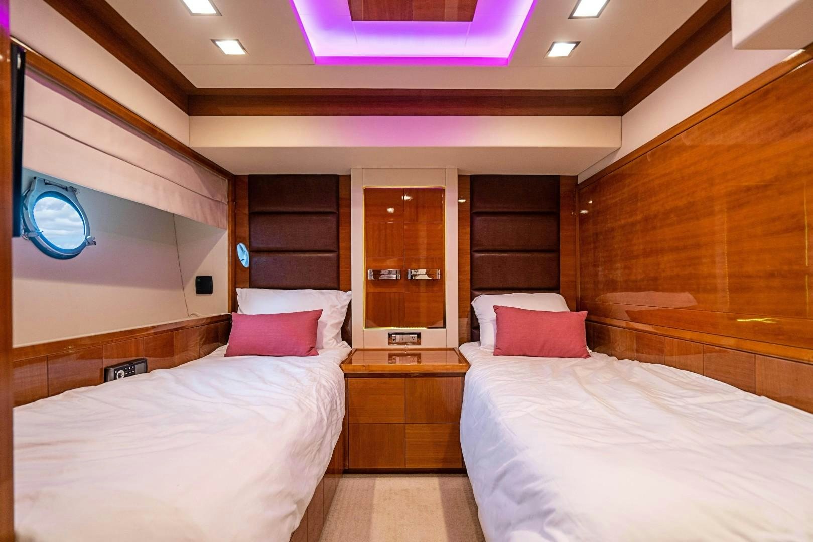 a room with a couple of beds aboard Blue Yacht for Sale