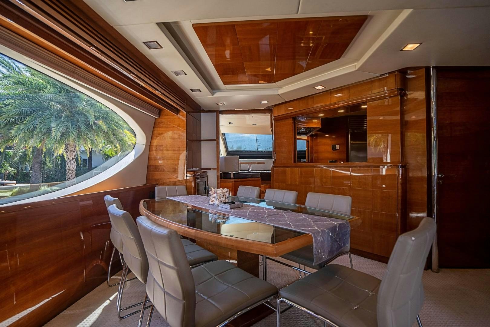 a room with a table chairs and a tv aboard Blue Yacht for Sale