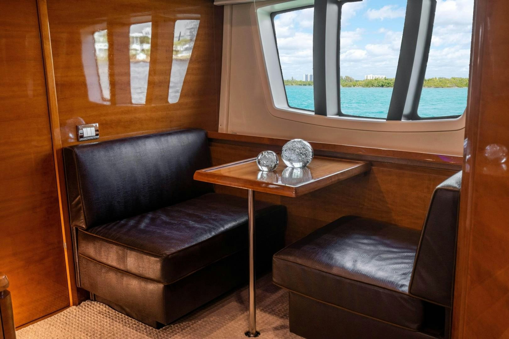a living room with a coffee table and a window aboard Blue Yacht for Sale