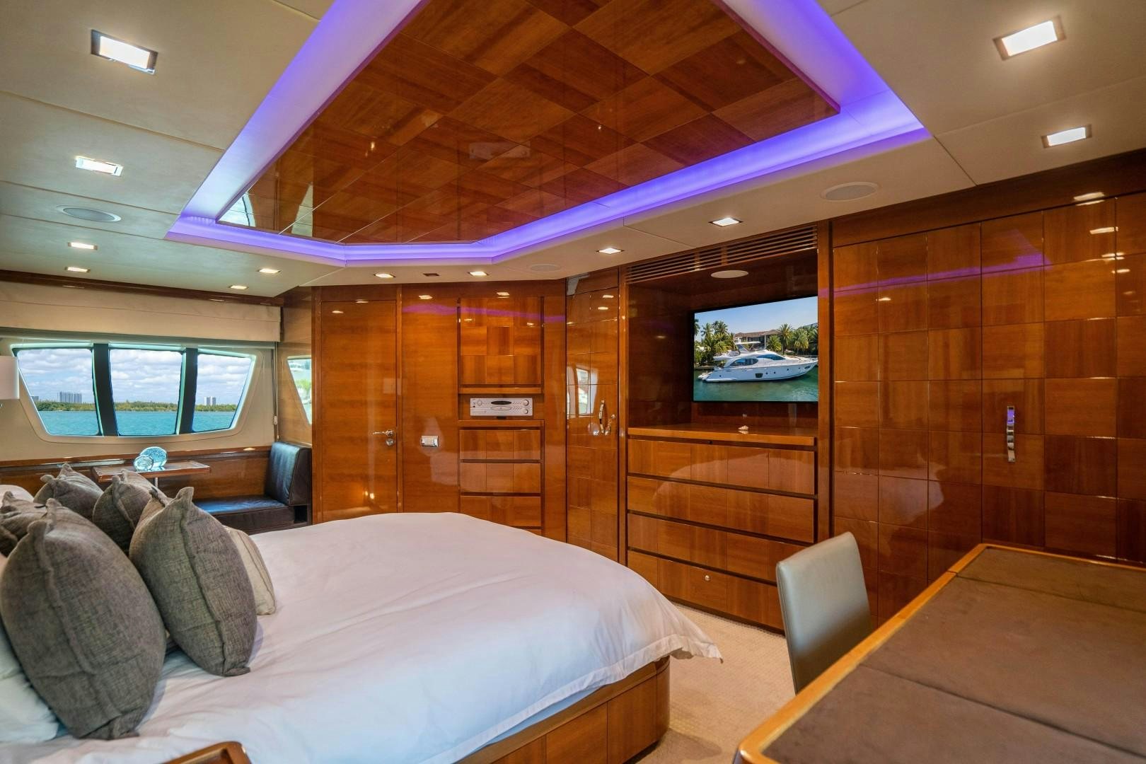 a room with a bed and a table aboard Blue Yacht for Sale