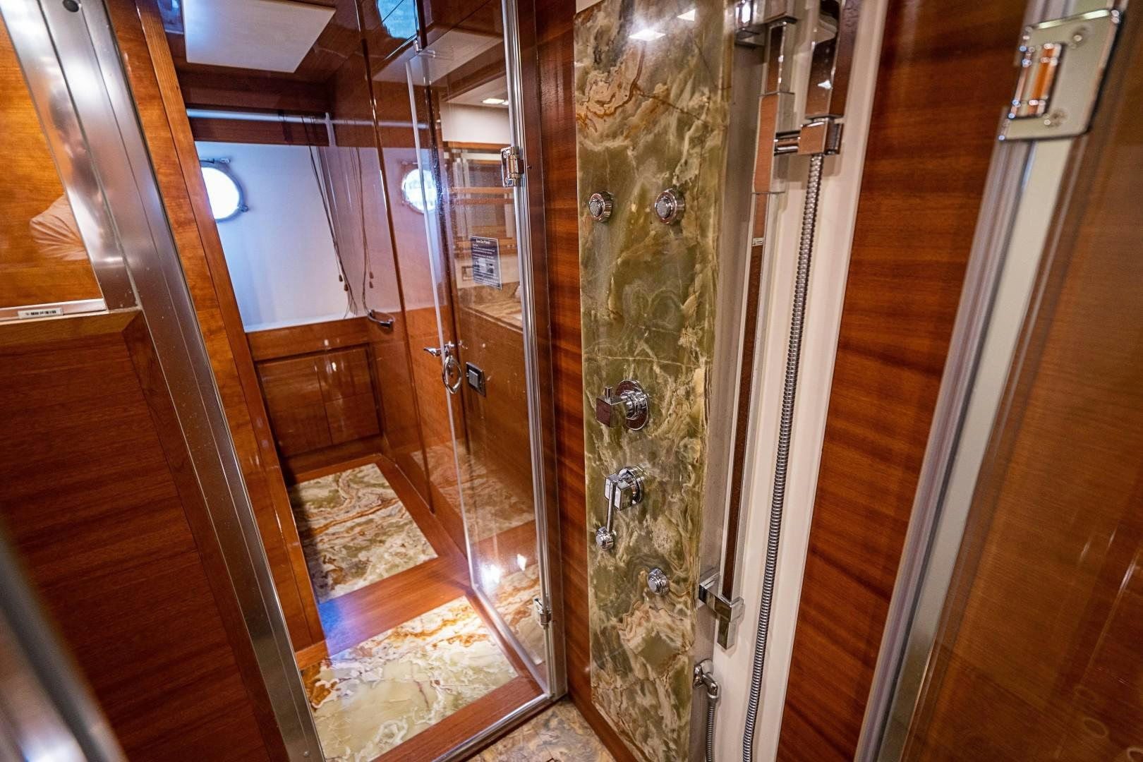 a hallway with glass doors aboard Blue Yacht for Sale