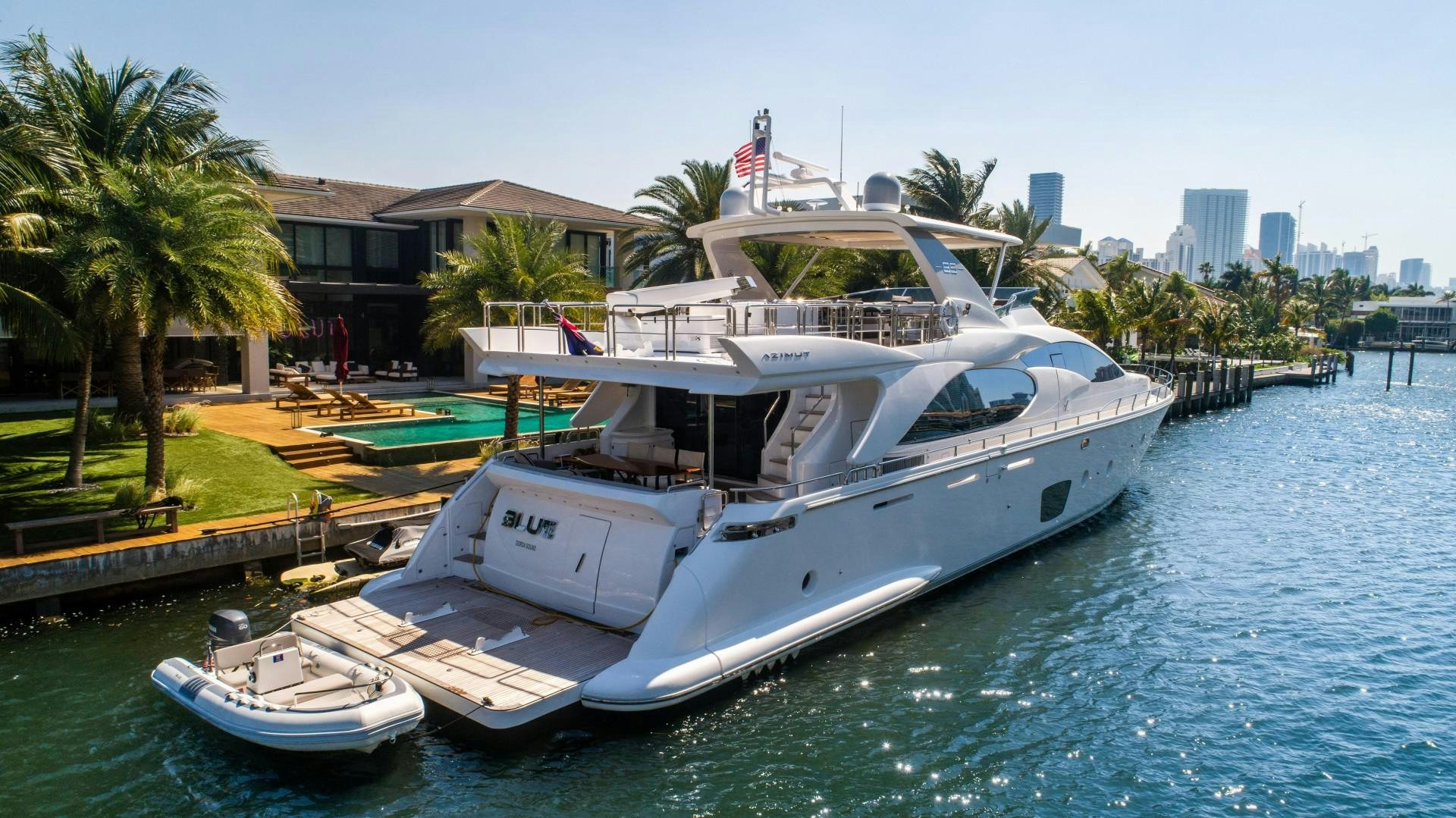 a boat docked at a pier aboard Blue Yacht for Sale
