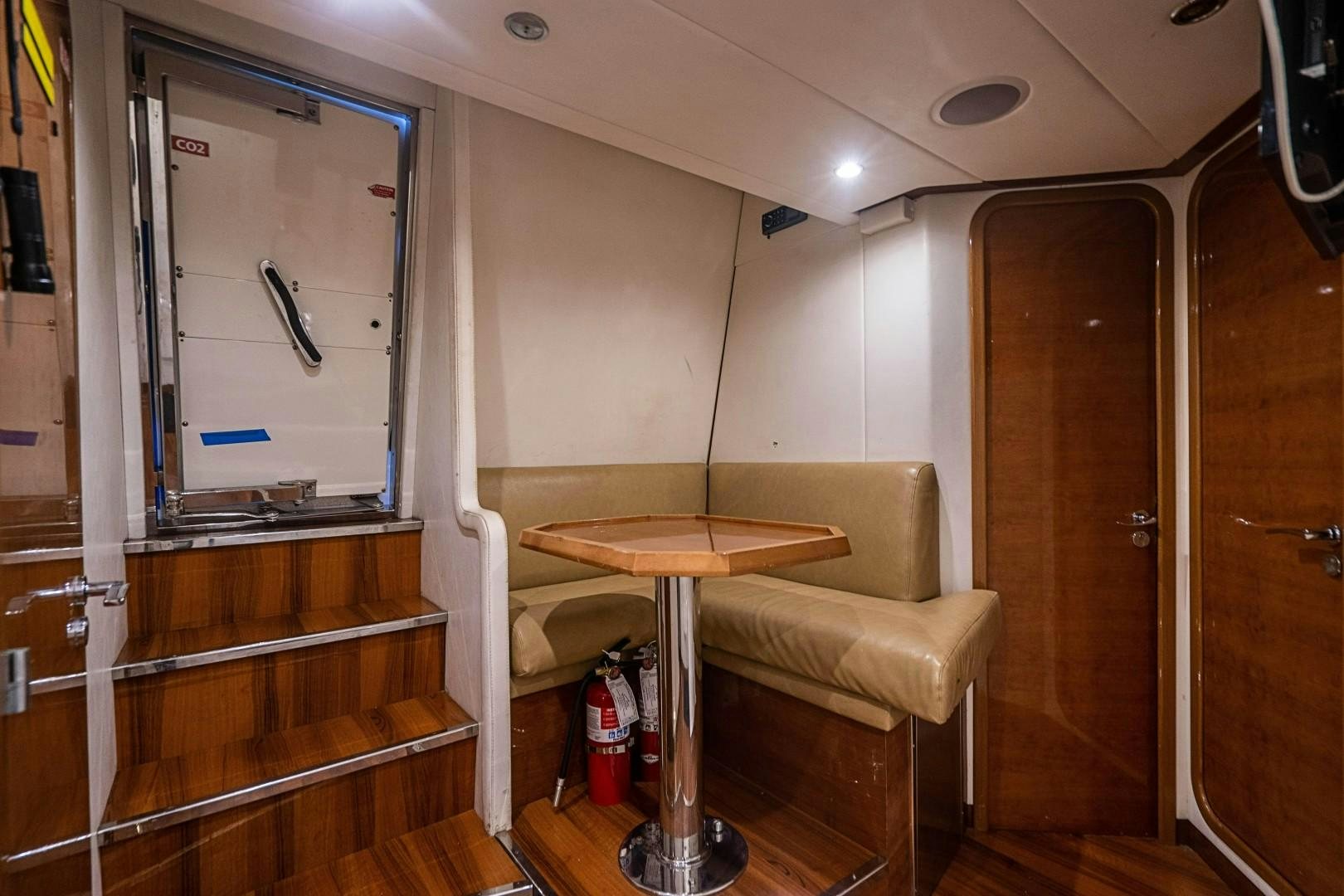 a room with a table and a chair aboard Blue Yacht for Sale