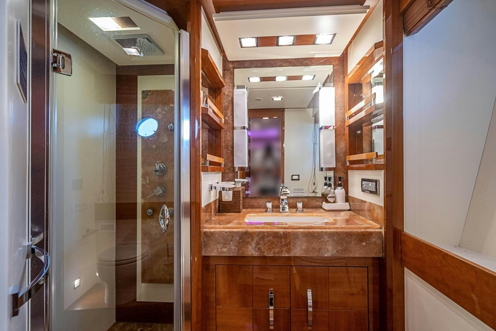 a bathroom with a sink and a mirror aboard Blue Yacht for Sale