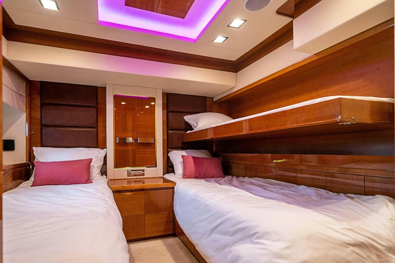 a room with a bed and a window aboard Blue Yacht for Sale