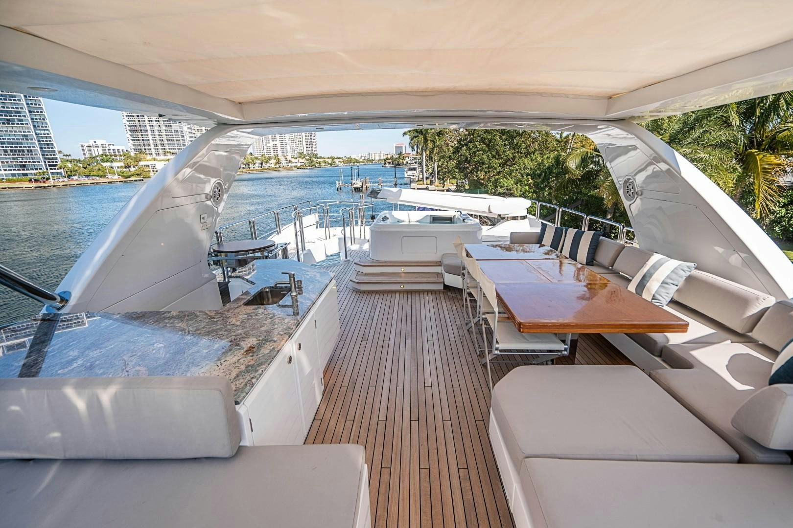 a deck with a pool and a deck with a view of a city aboard Blue Yacht for Sale