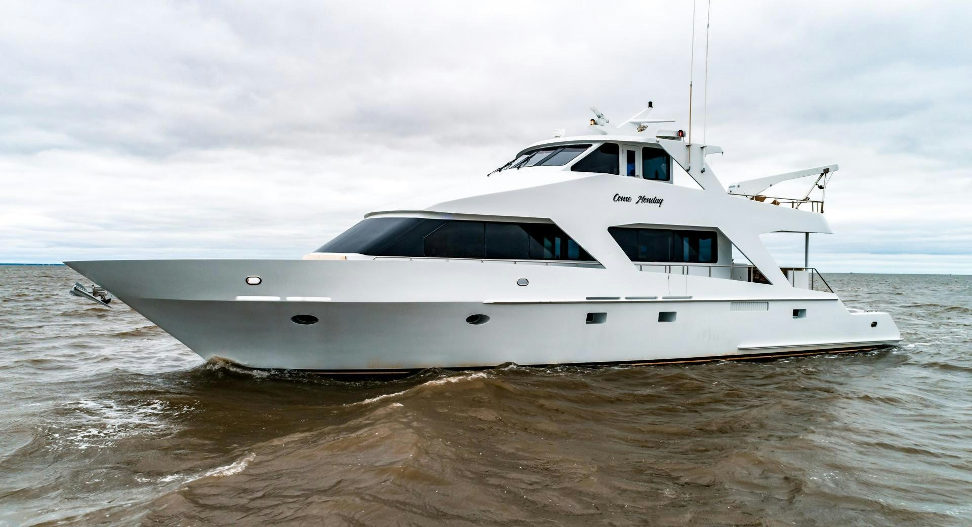 a white boat in the water aboard COME MONDAY Yacht for Sale