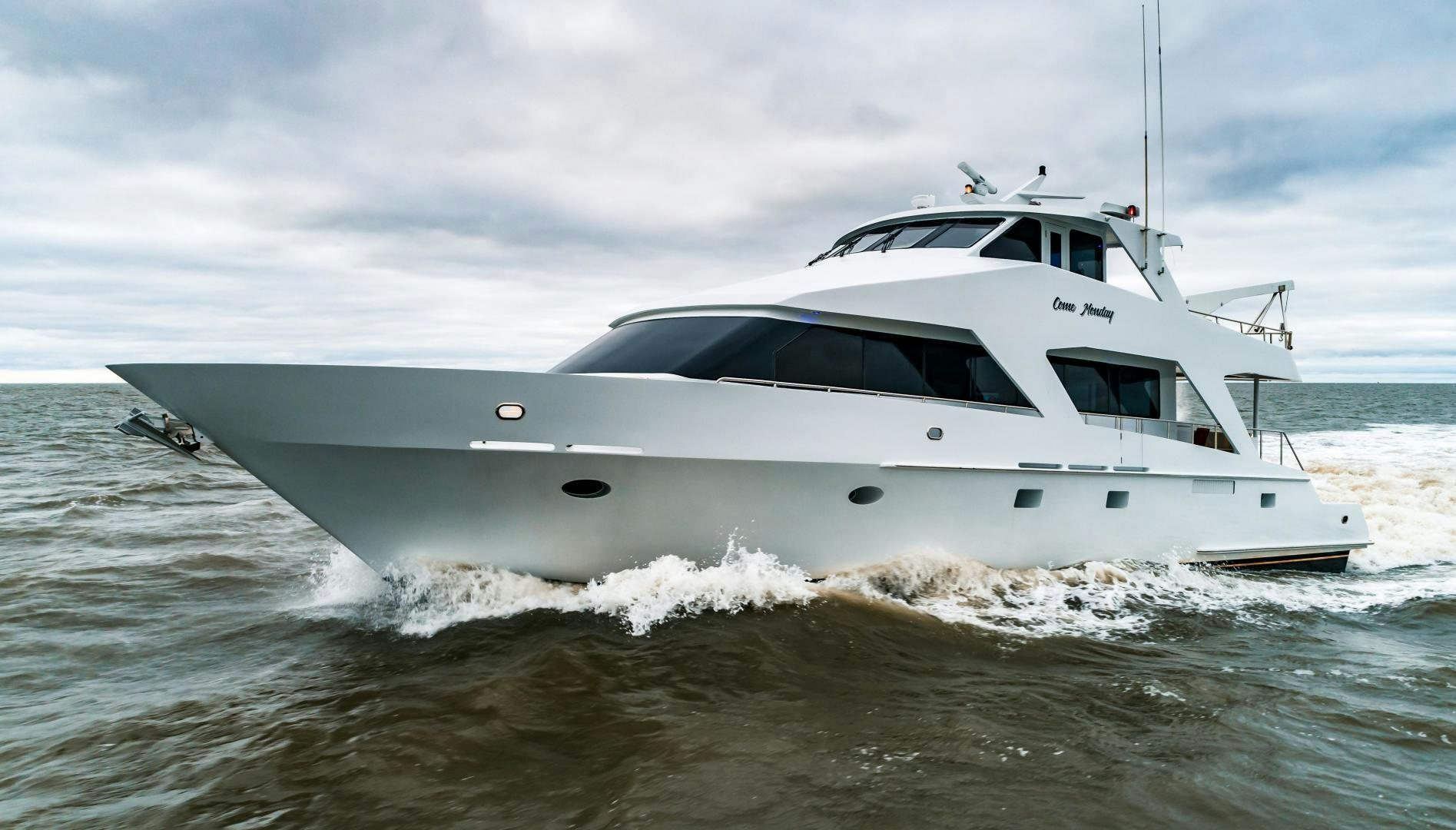 a white boat in the water aboard COME MONDAY Yacht for Sale