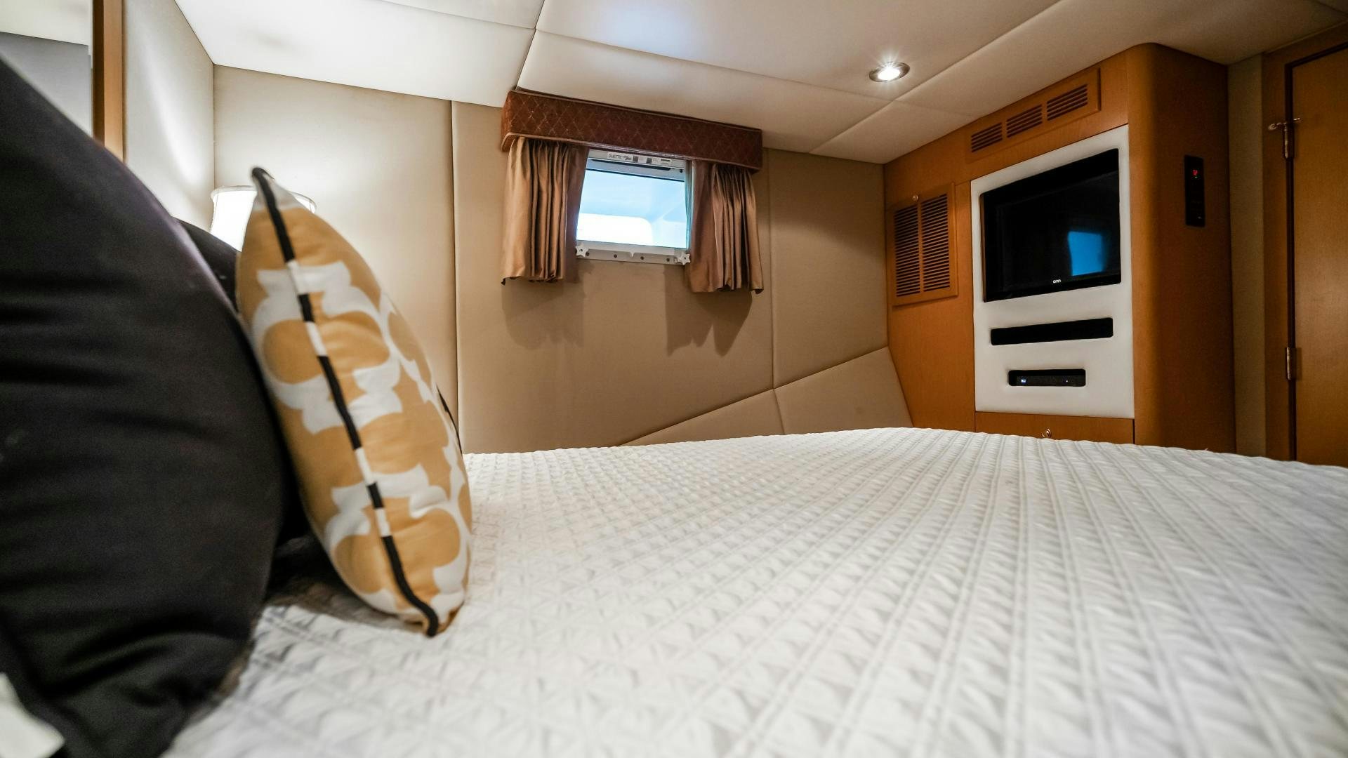 a bed with a white sheet and pillows aboard COME MONDAY Yacht for Sale