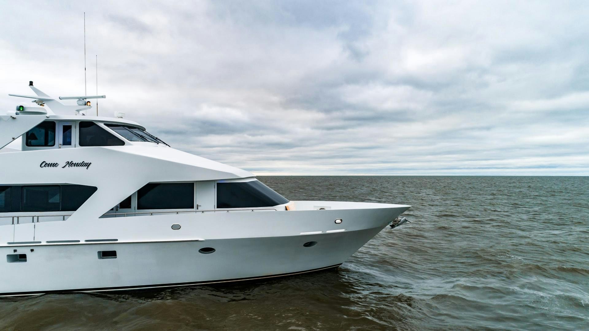 a white boat on the water aboard COME MONDAY Yacht for Sale