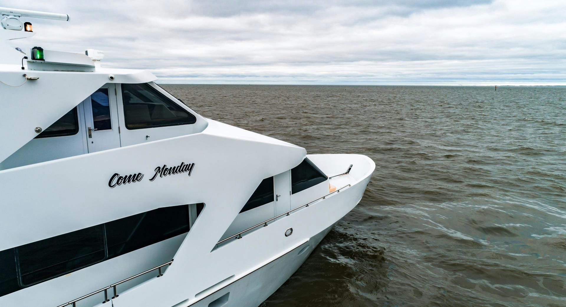 a white yacht in the water aboard COME MONDAY Yacht for Sale