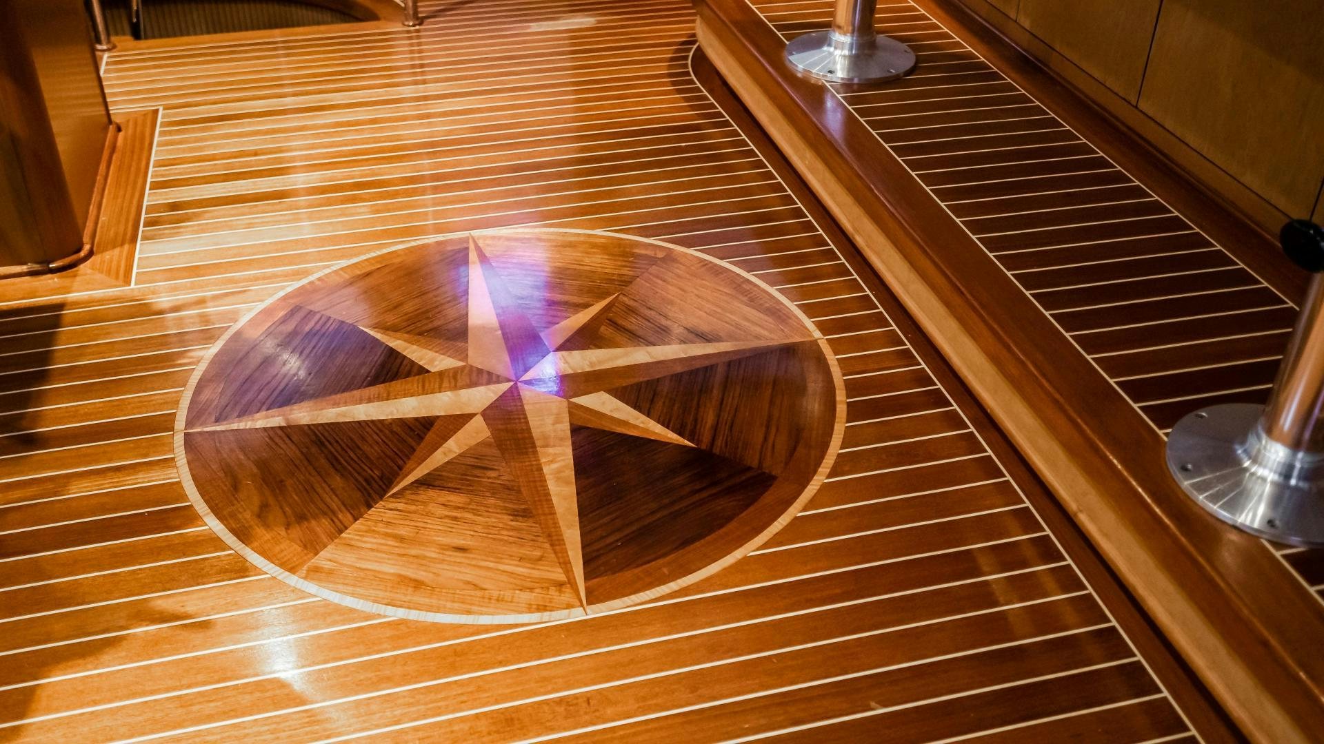 a circular object on a wooden surface aboard COME MONDAY Yacht for Sale