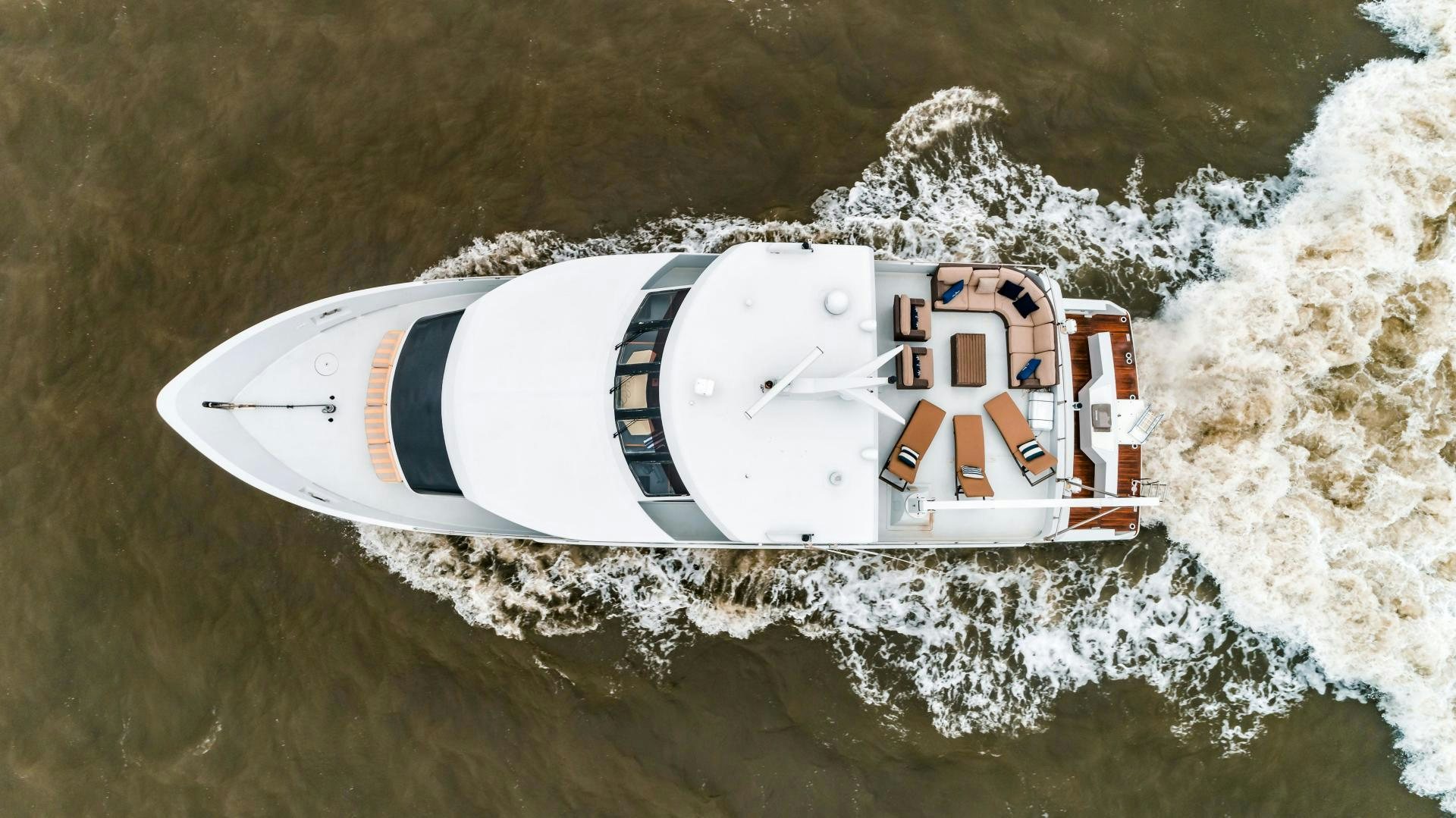 a white and red race car driving through water aboard COME MONDAY Yacht for Sale