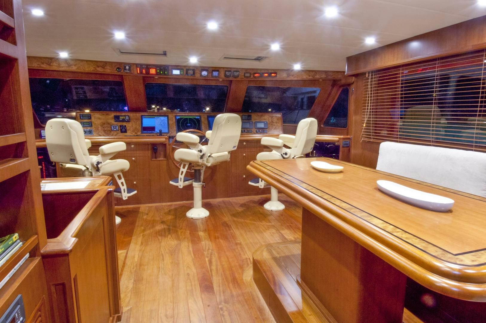 a room with tables and chairs aboard No Name Yacht for Sale