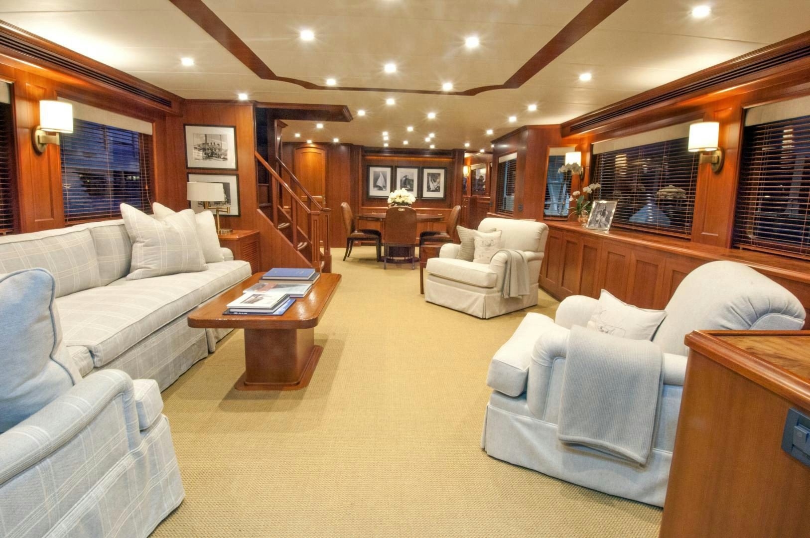 a living room with white couches aboard No Name Yacht for Sale