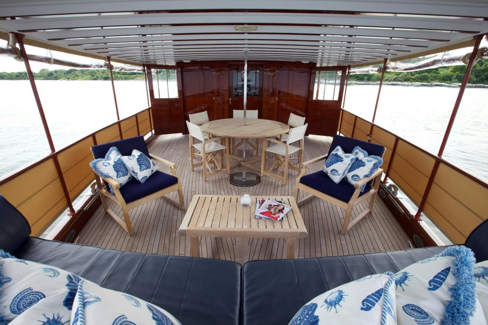 a large boat with a table and chairs on it aboard ENTICER Yacht for Sale