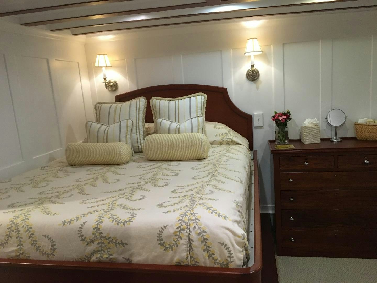 a bed with a white comforter aboard ENTICER Yacht for Sale