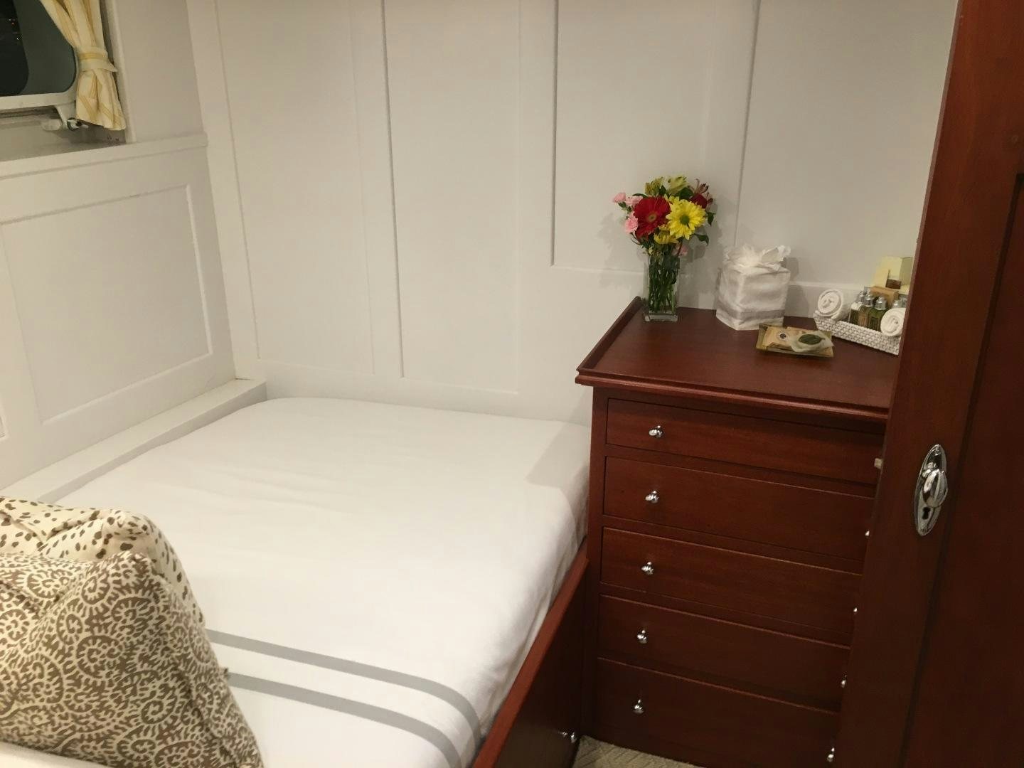 a bed with a white sheet and a white bed spread aboard ENTICER Yacht for Sale