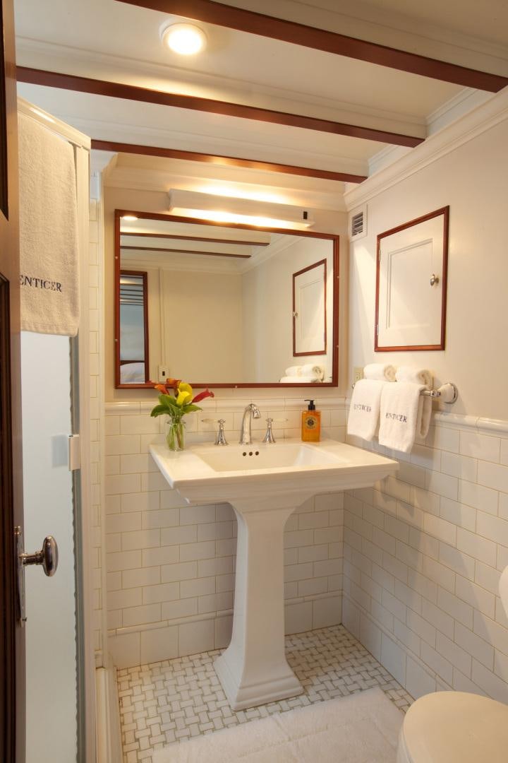 a bathroom with a sink and mirror aboard ENTICER Yacht for Sale