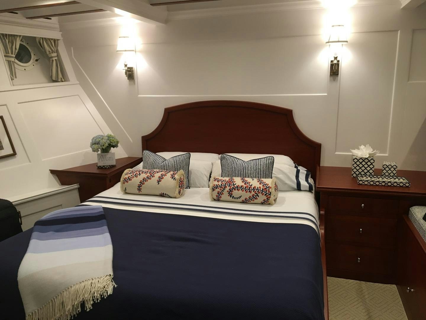 a bed with blue sheets aboard ENTICER Yacht for Sale