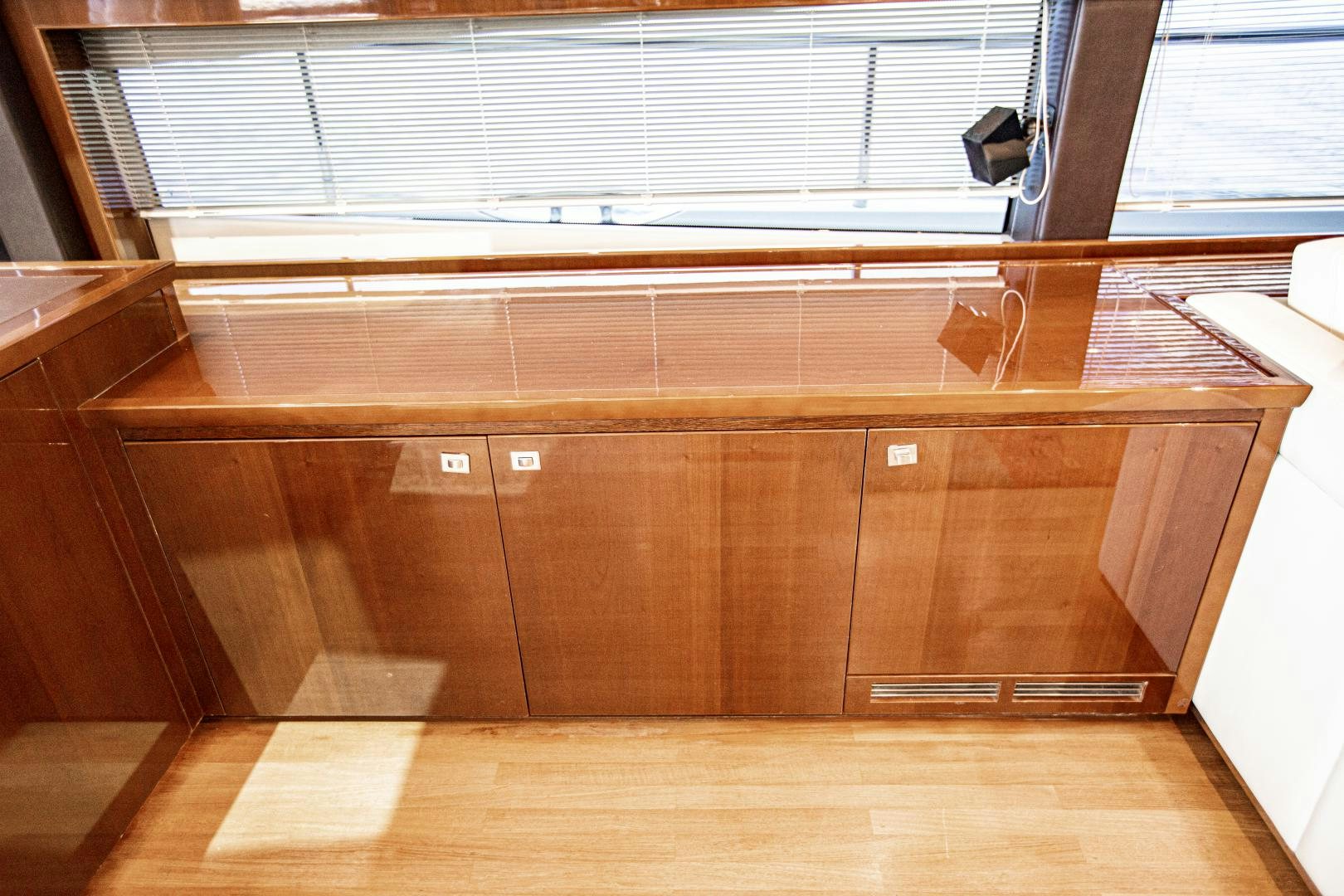 a wooden cabinet with a black object on it aboard LAS BRISAS Yacht for Sale