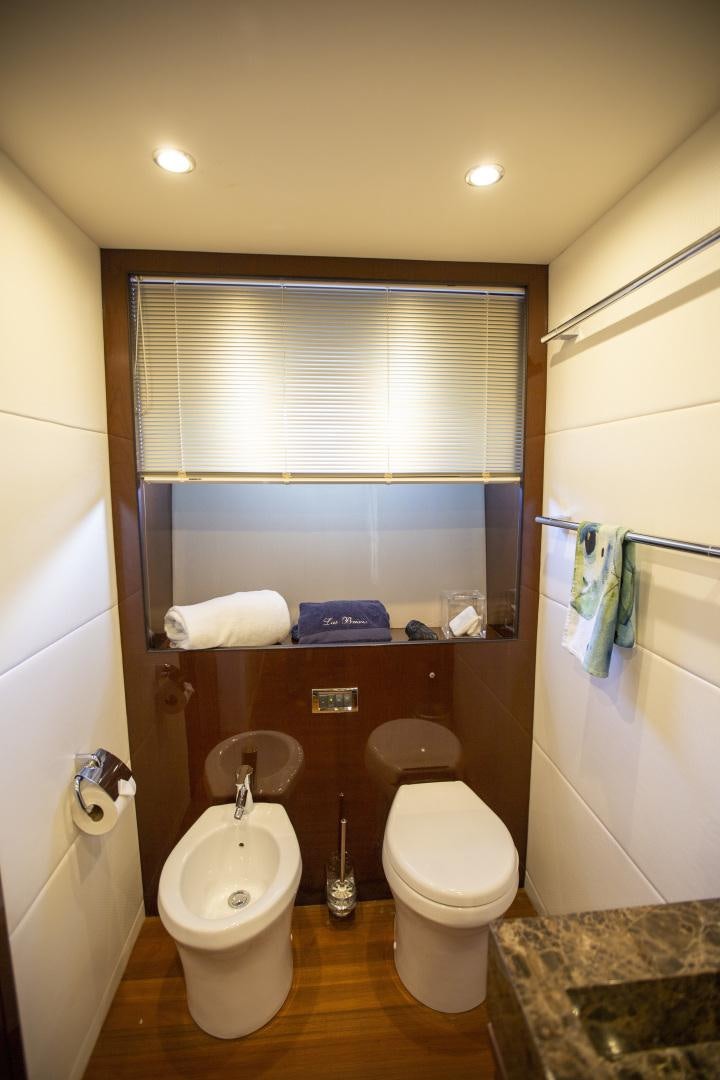 a bathroom with a toilet and a sink aboard LAS BRISAS Yacht for Sale