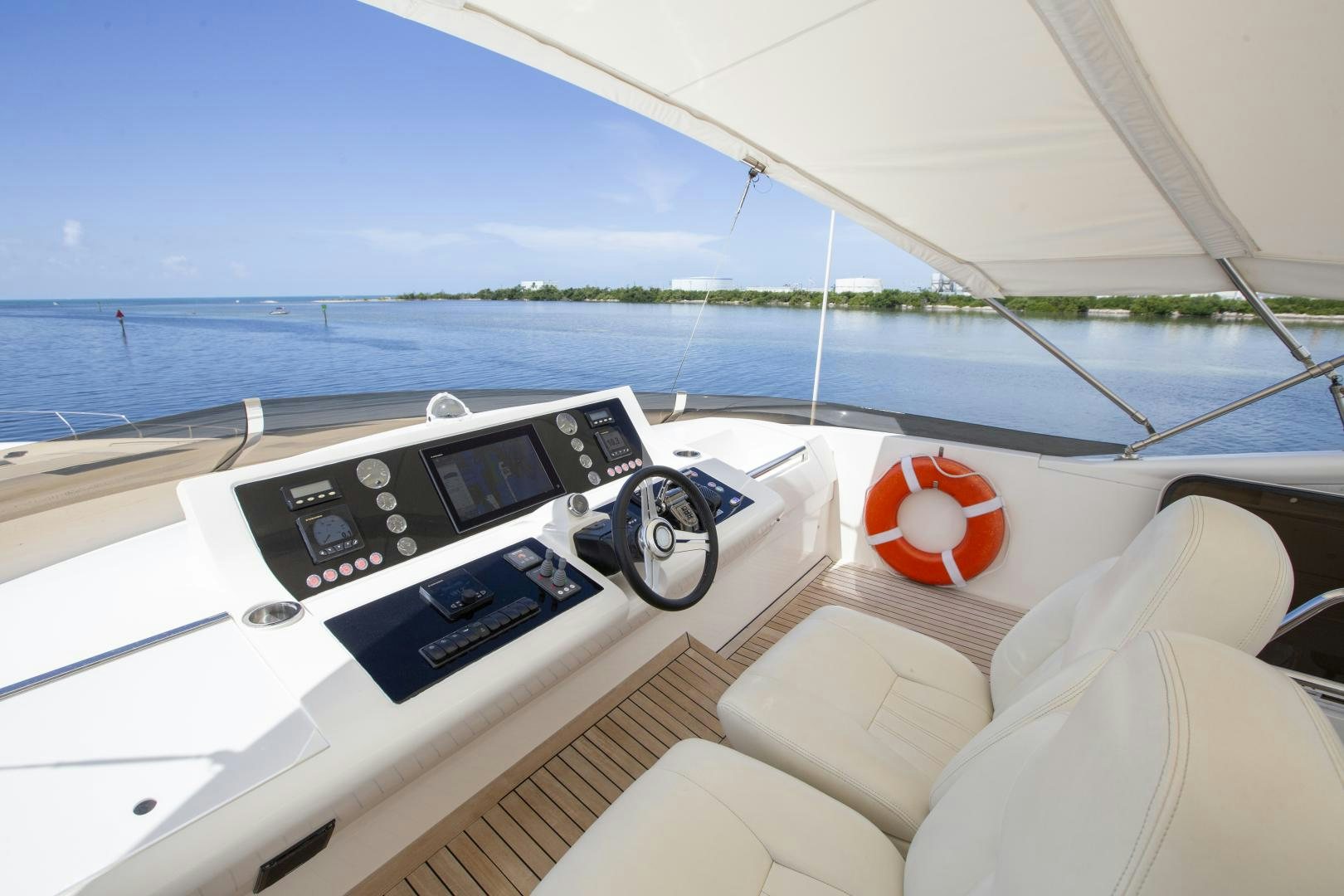 a boat with a steering wheel and a boat in the water aboard LAS BRISAS Yacht for Sale