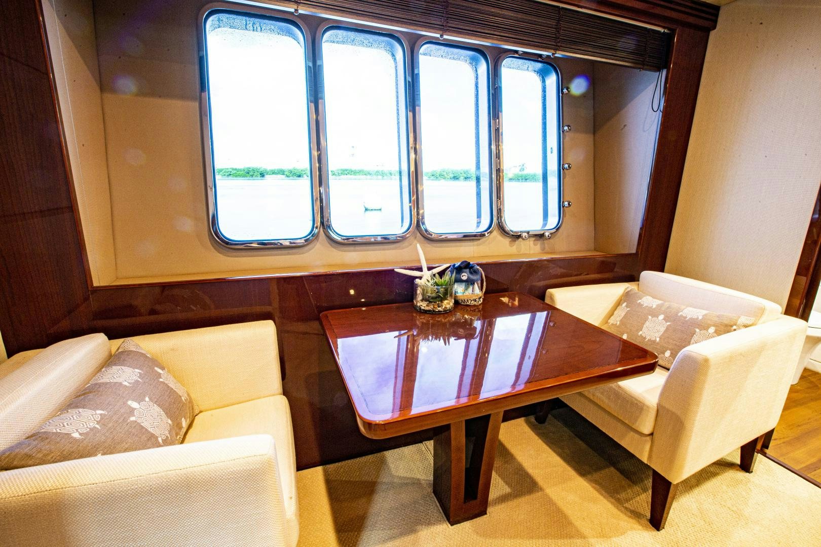 a table with chairs and a couch aboard LAS BRISAS Yacht for Sale