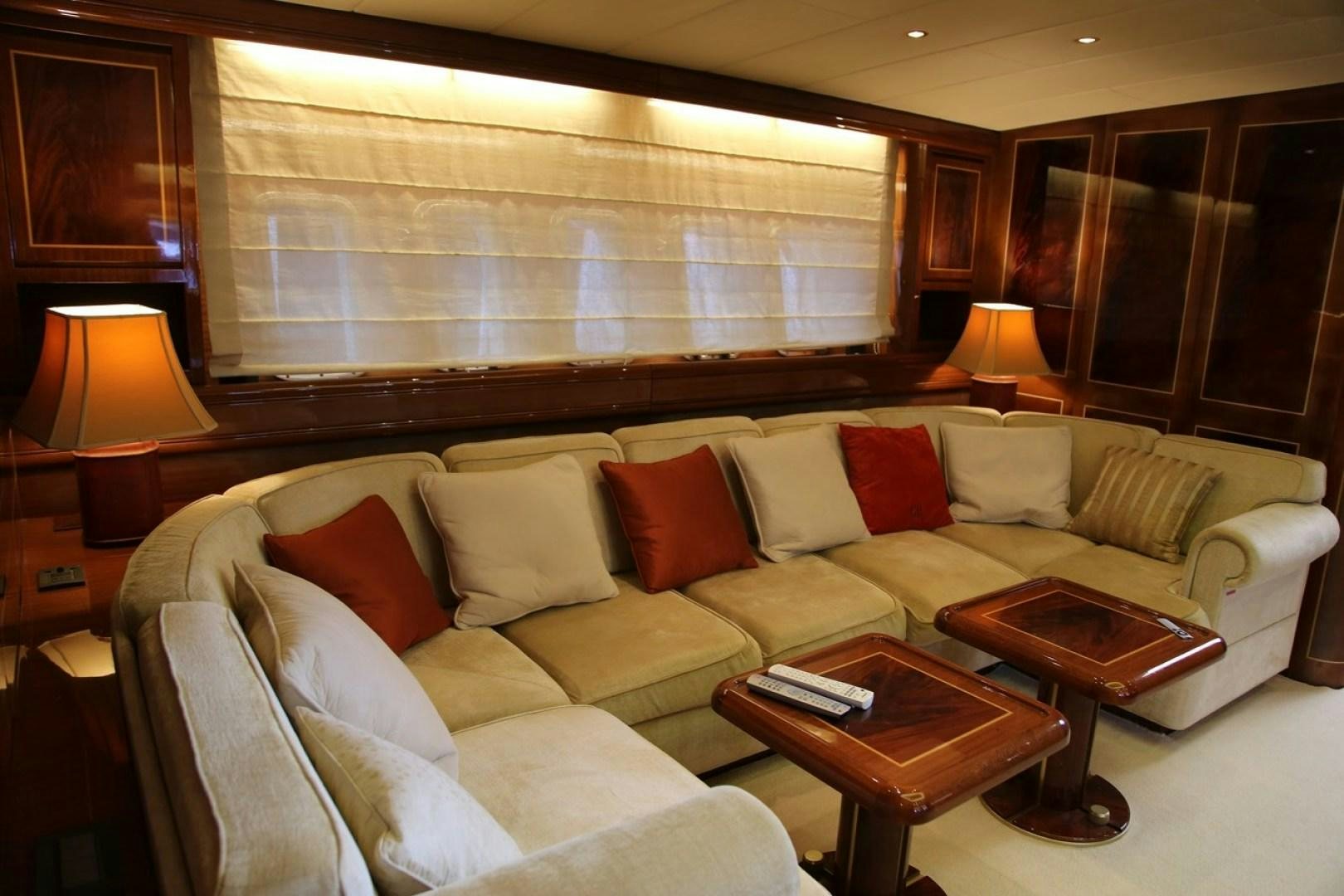 a living room with a couch and a table aboard VIP ONE Yacht for Sale